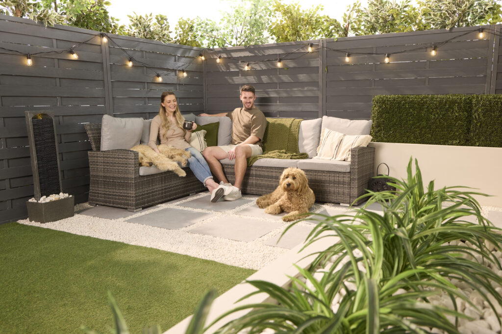 Couple and their dog relaxing on a resin bound garden patio